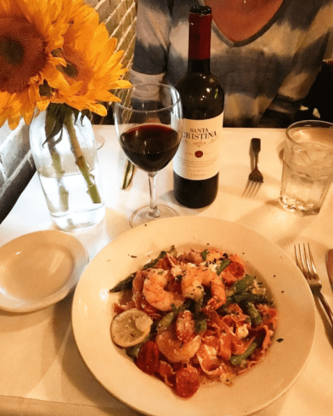 pasta with shrimp and a glass of wine