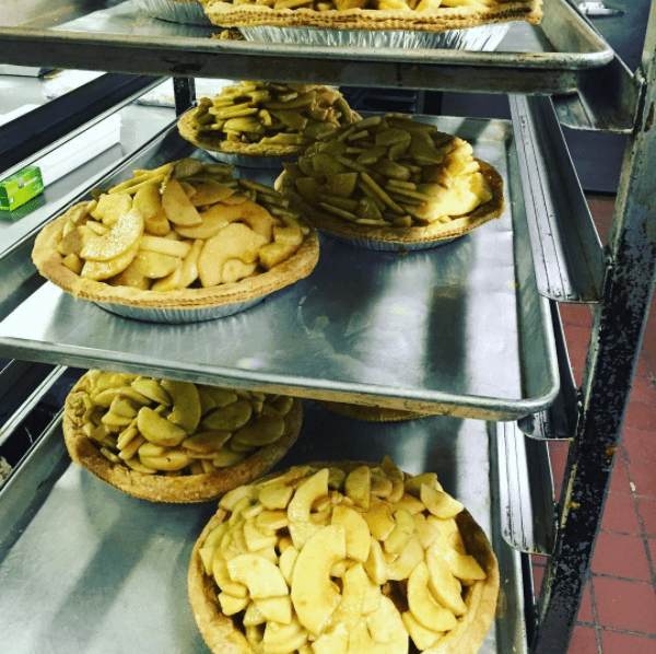 apple pies on racks ready to be baked