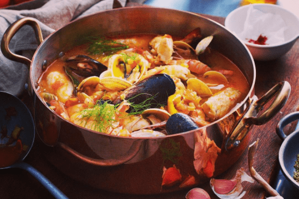 seafood stew in copper pot