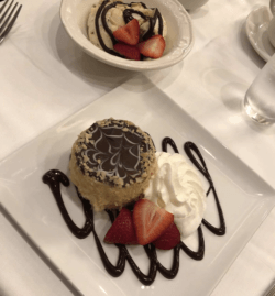 bosto cream pie with whip cream and strawberries