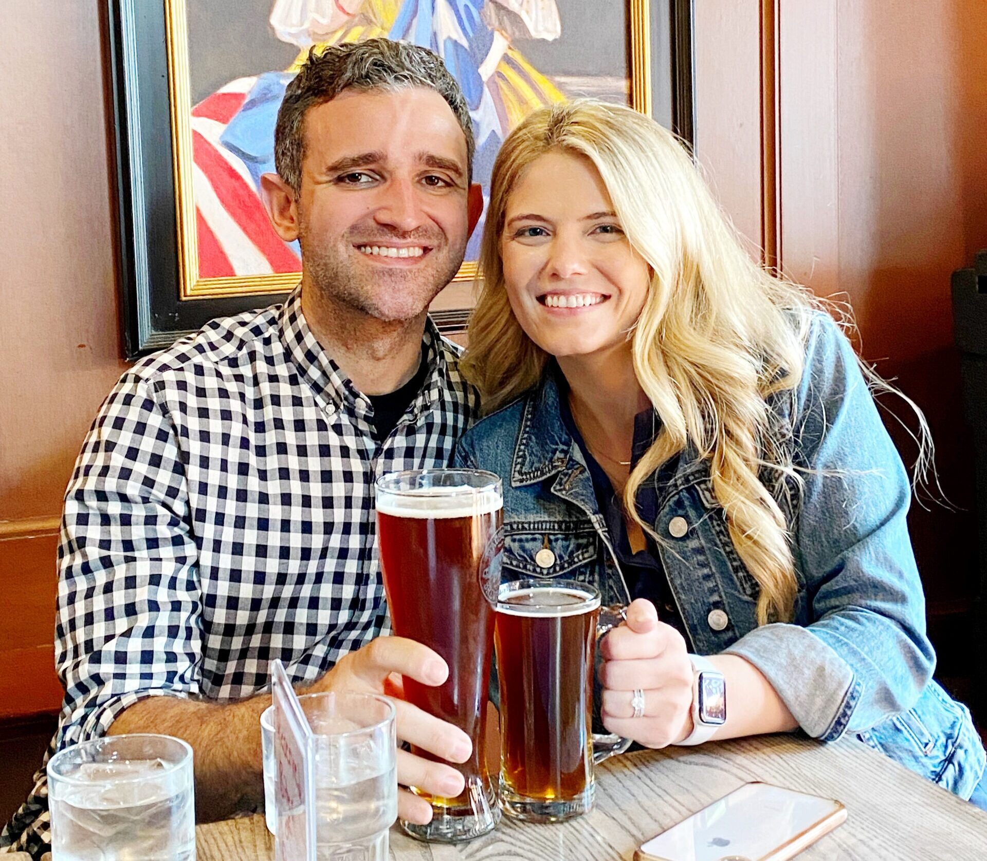 a couple posing for a picture while holding food