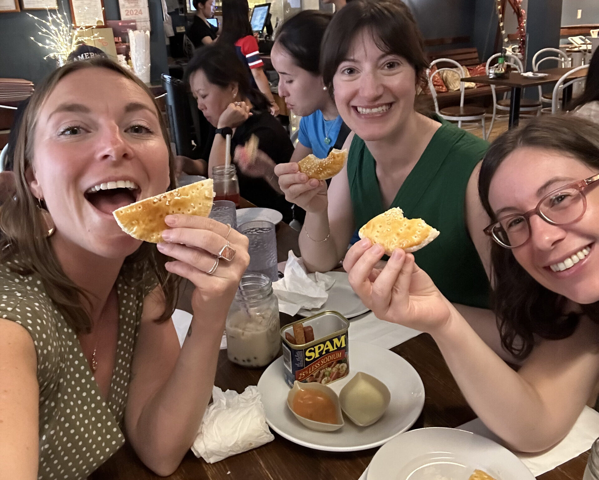 a group of people posing with food