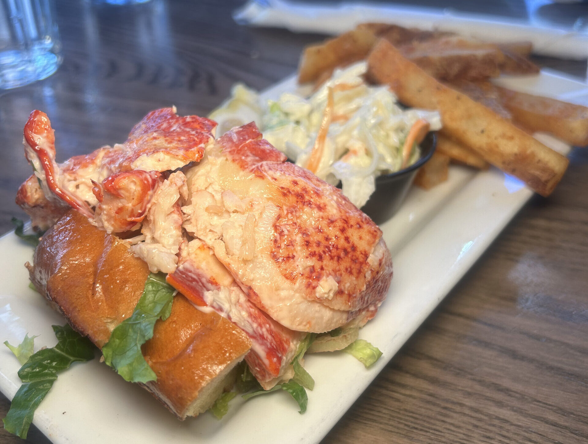 a closeup of a New England lobster roll sandwich