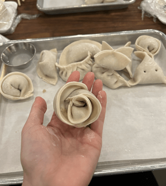 a raw handmade dumpling in a hand